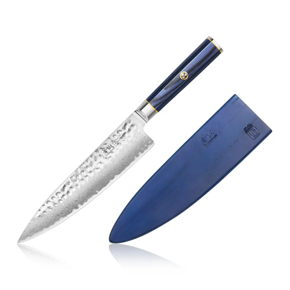 The Cangshan Kita 8-inch chef's knife, with a hammered Damascus blade, a blue handle and a blue sheath.
