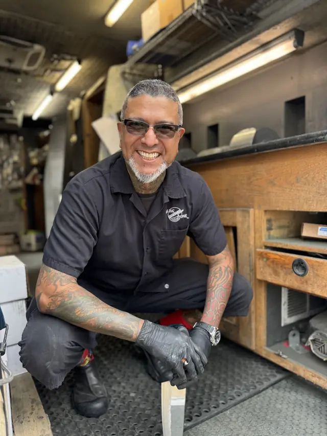 Joey, senior knife sharpener, inside a Rolling Sharpening Stone truck